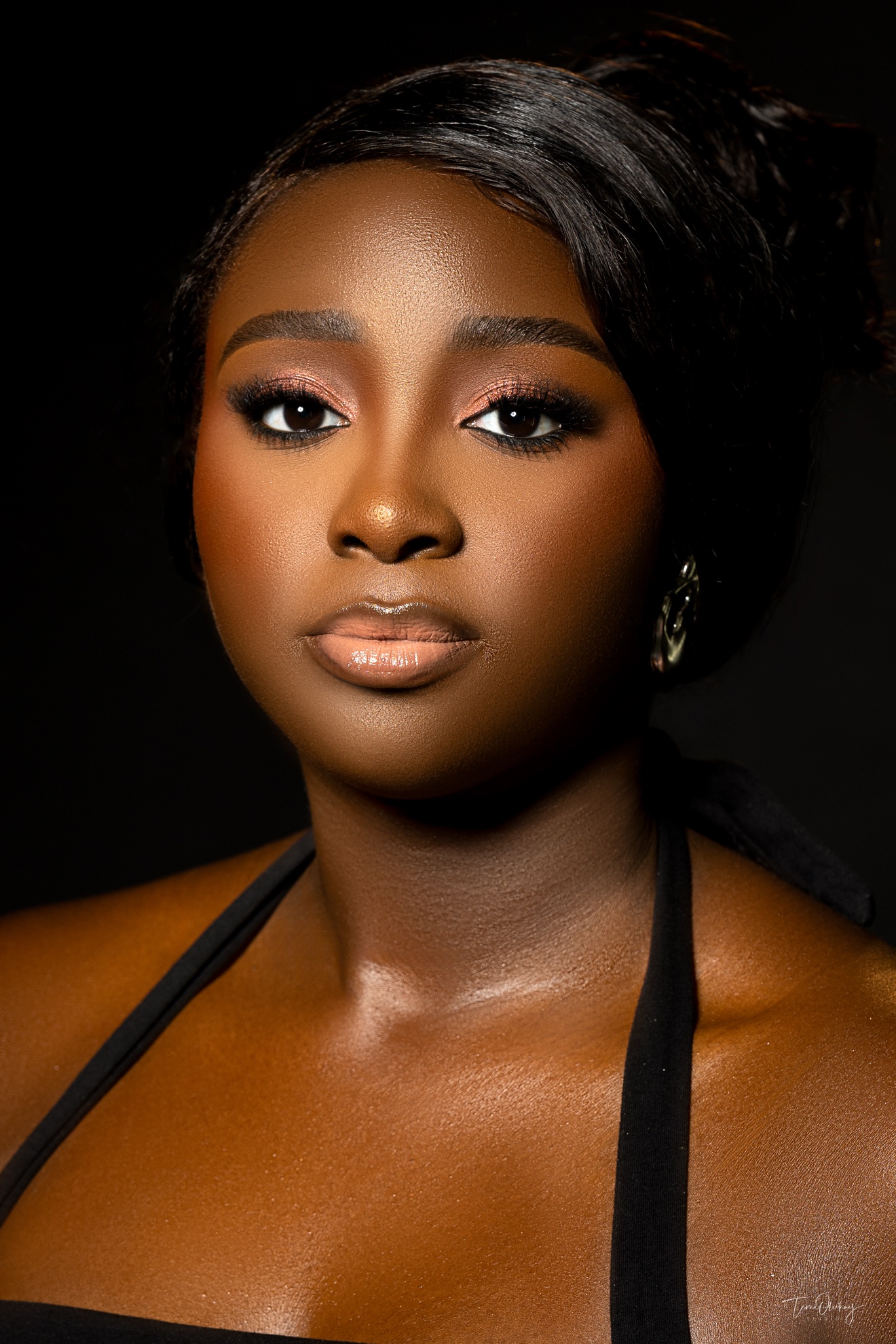 Beauty close-up portrait with glam makeup on black backdrop