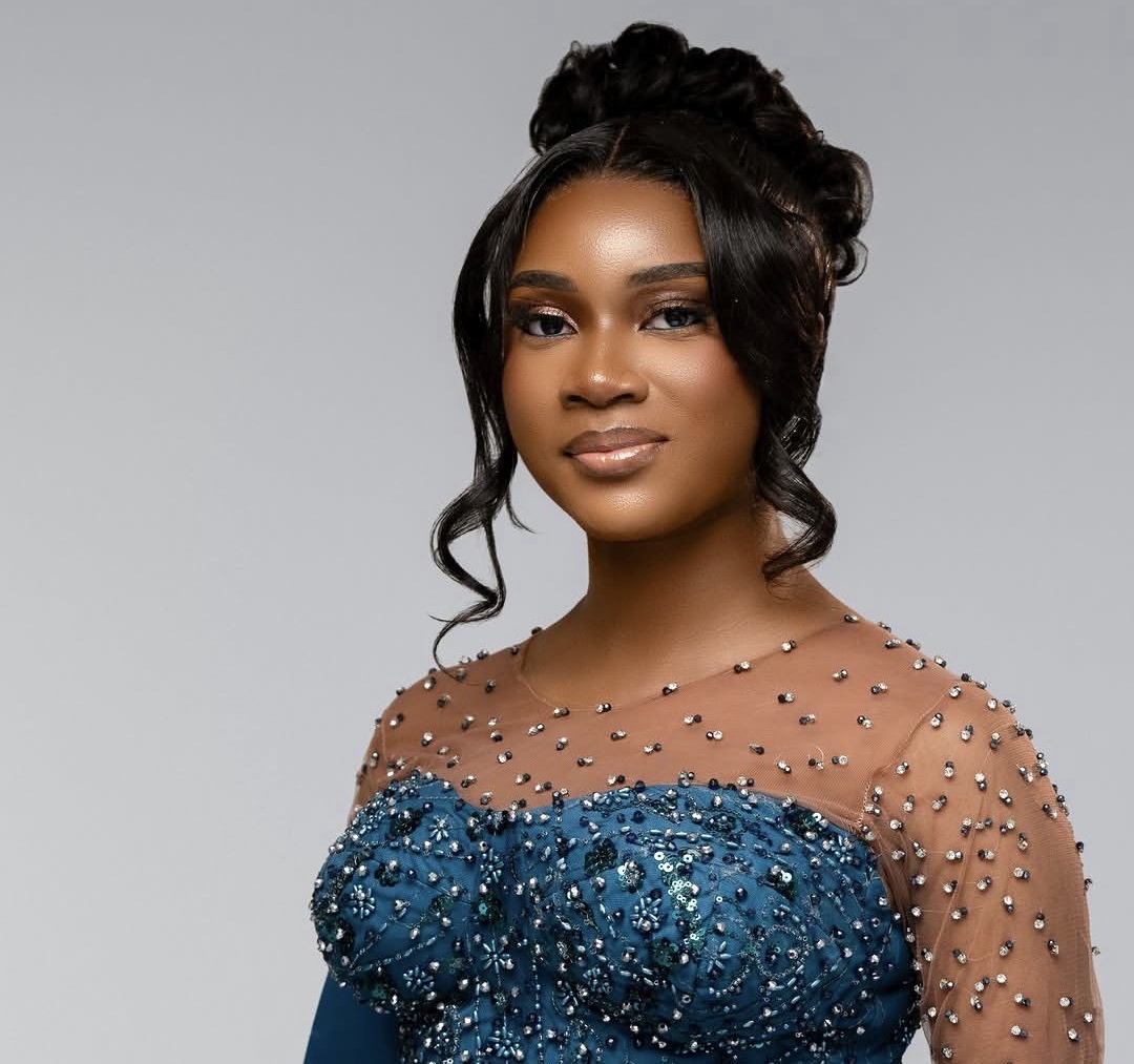 Portrait in blue beaded gown on light grey backdrop